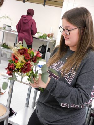 Students design flower arrangements during a free design lab.