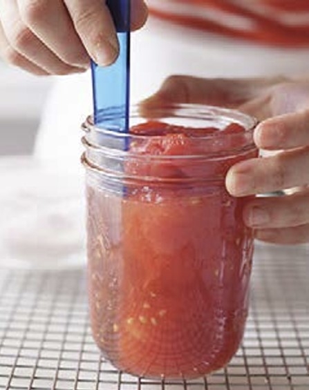 someone sliding a knive around the inside edge of a jar.