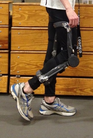 An individual mid-step assisted by a piston like knee apparatus.