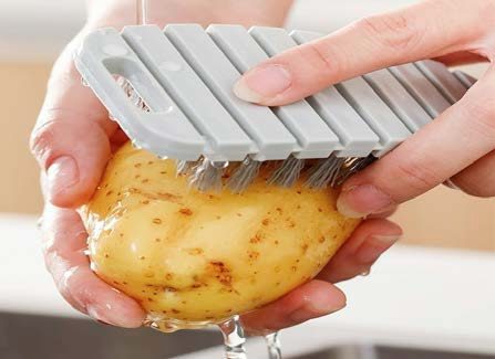 Washing potato with brush with clean running water. Photo credit Walmart - Hesroicy Fruit Cleaning Brush Food Grade