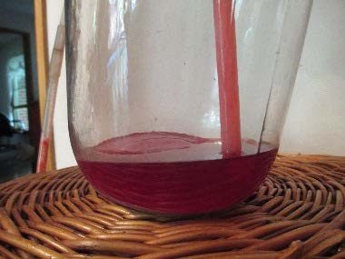 sediment and liquid in a glass jar