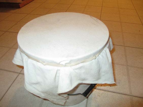 A white cloth over a 5-gallon bucket